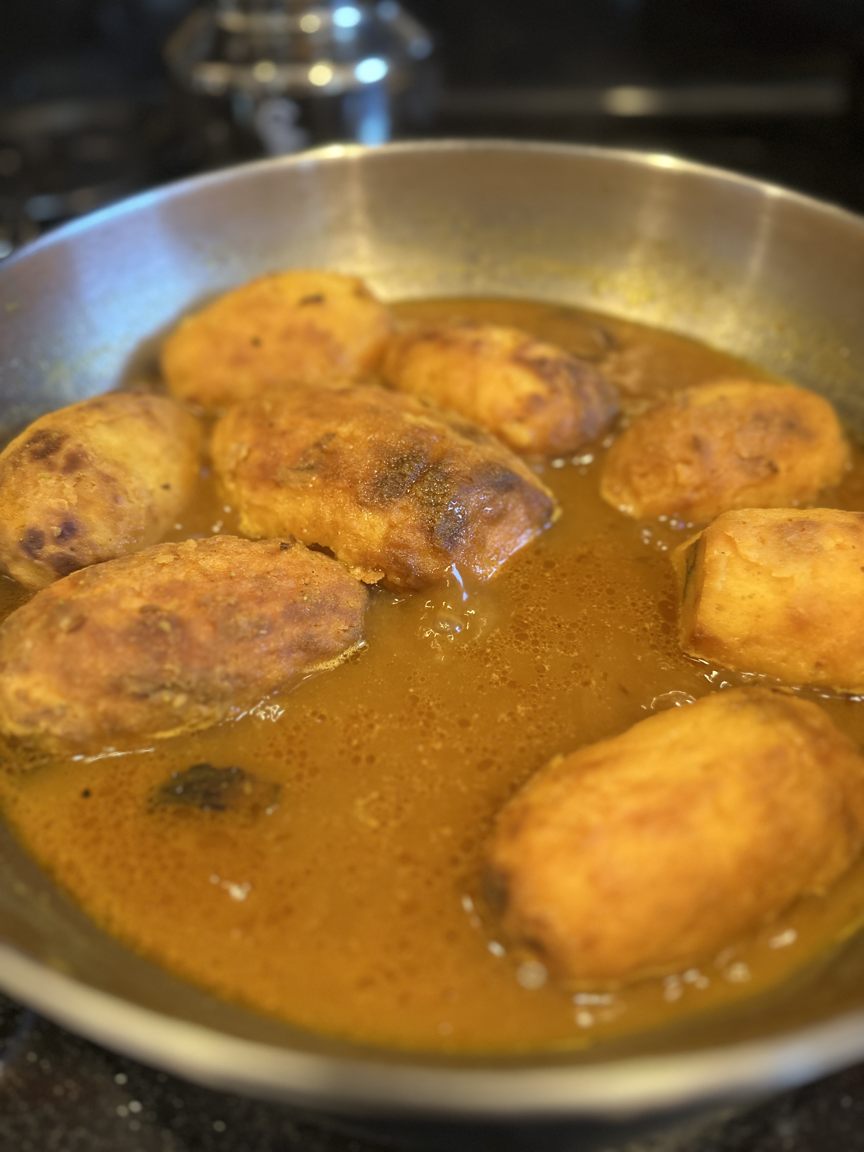 Potatoes simmering as the sauce reduces